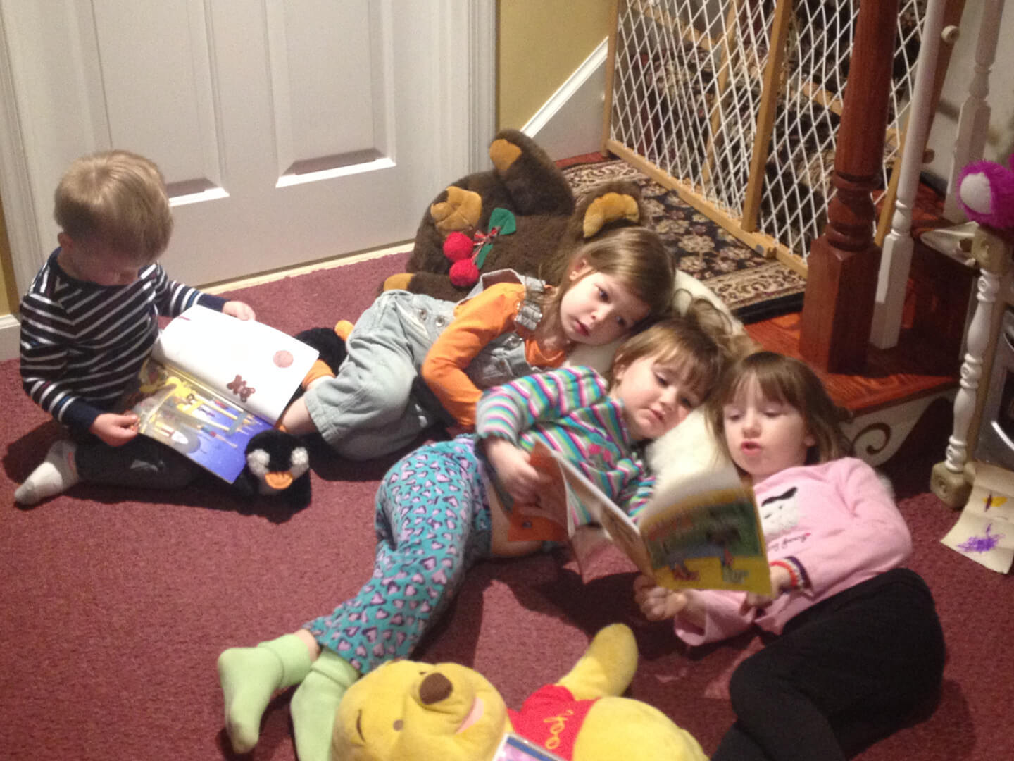 Four children reading books together
