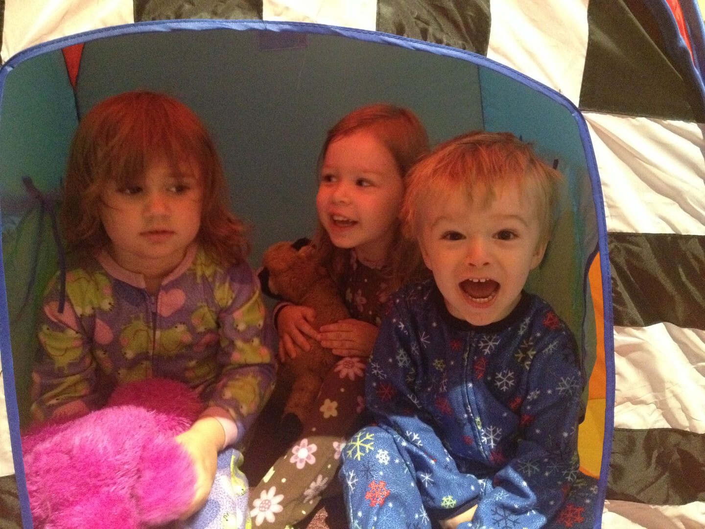 Three kids in a camping tent